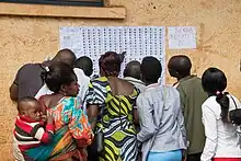 Électeurs cherchant leurs noms sur les listes pour identifier leurs bureaux de vote