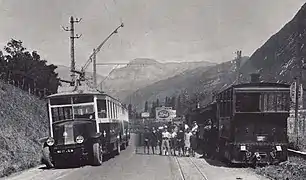 Photographie en noir et blanc montrant l’éléctrobus et le tramway stationnées à Saint-Jeoire-Prieuré à la fin des années 1920.