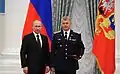Avec Vladimir Poutine, lors de la remise au cosmonaute de récompenses.