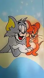 Peinture murale d'un intérieur avec Tom (à gauche) et Jerry la souris.