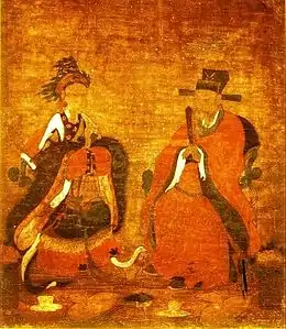 Peinture présentant deux personnages, assis et en costumes opulents, une femme est à gauche et un homme à droite.