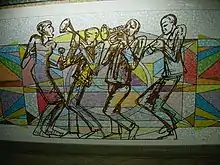 quatre silhouettes (trois musiciens de jazz et une danseuse) en traits noirs sur un fond géométrique de couleurs vives