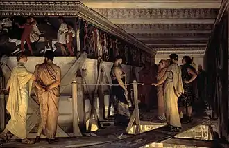Photographie en couleurs d'un tableau de style réaliste dans lequel des hommes portant la tenue antique parcourent un échafaudage élevé, le long d'une frise fraîchement peinte.