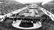 Photographie noir et blanc montrant une foule dans un stade.