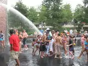 The fountain spouting water on frolicking children