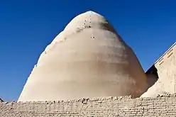 Photographie d'un bâtiment en terre de forme conique