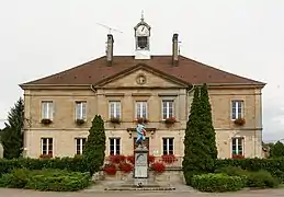 Photo couleur d'un bâtiment de deux étages. Centre de trois fenêtres entouré de deux ailes de deux fenêtres.