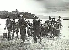 Infantrymen coming ashore from landing craft