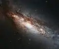 Gros plan sur les veines obscures de poussière de NGC 660. (ESA/Hubble & NASA)