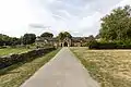 Abbaye Notre-Dame de Bon-Repos : le porche d'entrée vu depuis l'extérieur de l'abbaye.