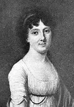 Gravure ronde en noir et blanc, présentant le haut du corps d'une femme en robe blanche décolletée, de trois-quarts et le visage tourné vers le spectateur, aux cheveux mi-longs et noirs.