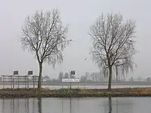 Confluent Meuse barrée (premier plan) et Waal (derrière l'isthme), en face de Woudrichem.