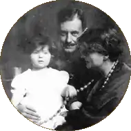 photographie en noir et blanc. Walter Gropius au centre tient sa fille Manon située à gauche. Sa femme Alma Mahler est à droite.