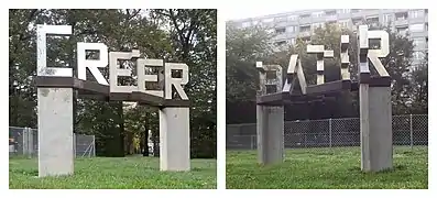 Ambigramme « Créer / Bâtir », sculpture de l'artiste Michel Schnider, à Onex (canton de Genève), en 2018, observé selon deux angles de vue.