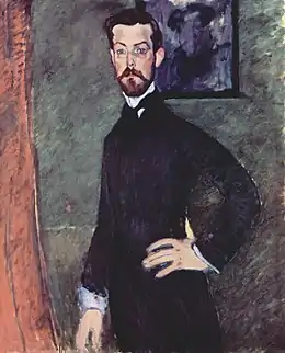 Portrait de trois quart d'un homme debout main sur la hanche, visage de face, barbiche, regard clair