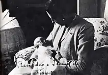 Photo noir et blanc d'une femme portant un bébé.