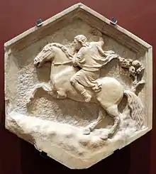 Bas-relief hexagonal figurant un homme sur un cheval cabré.
