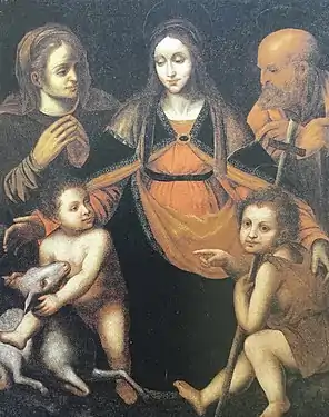 Peinture représentant un groupe formé par une femme assise encadrée par un vieillard et une vieille femme, un enfant chevauchant un agneau et un autre enfant le désignant.