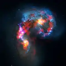 Cette image est une composition des données en onde radio captées par le réseau de radiotélescopes ALMA et en lumière visible provenant du télescope spatial Hubble.