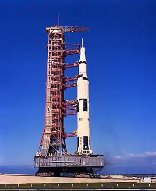 La Saturn V attaque la rampe du pas de tir construit au sommet d'une petite colline artificielle. Notez l'inclinaison de la plateforme maintenant la fusée verticale (Apollo 11, 1969).