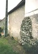 Vue d'un massif de pierres partiellement encastré dans un mur moderne.