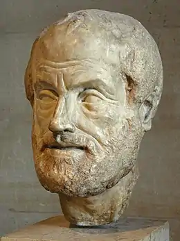 Tête de marbre sculpté représentant un homme barbu au grand front dégarni.