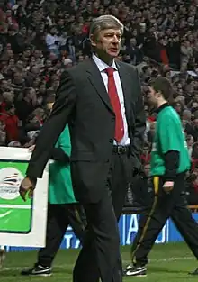 portrait d'un homme, de profil, portant un costard et une cravate rouge