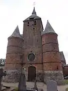 Clocher-donjon avec ses deux tours de défense.