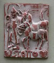 bas-relief avec un homme et des chevaux