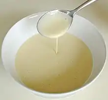 A spoon pouring batter into a bowl