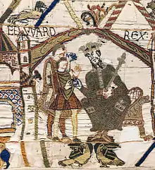 Représentation d'un homme barbu coiffé d'une couronne et portant un sceptre nommé EDWARD REX ; il se penche vers deux hommes à sa droite