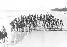 Photographie en noir et blanc d'une patrouille militaire montée sur des Carolina Marsh Tackies.