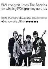 Les quatre Beatles, posant avec leurs instruments, dans une affiche promotionnelle.