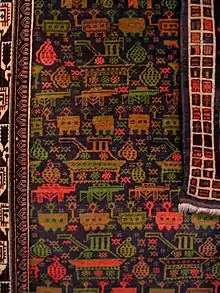 Tapis afghan à décor de chars, de grenades et de Kalachnikovs, Le Grand Jeu, coll. Michel Aubry, vu au musée de la tapisserie de Beauvais en 2012.