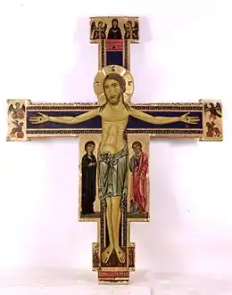 Crucifix italien du XIIIe siècle à la pinacothèque de Lucques, la Vierge est toujours à la droite de son Fils et saint Jean, l'apôtre préféré, à sa gauche. Les symboles des évangélistes sont de chaque côté du bras horizontal.