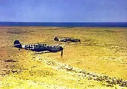 Photographie colorisée de deux avions survolant le désert.