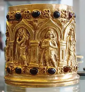 Reliquaire. Dévot, de face, et déités nimbées, de profil, en adoration. Or, grenats. Ier ou IIe siècle . British Museum