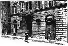 Illustration d'un bâtiment en briques au bord d'une rue. Une femme est à la porte et sur la rue se trouve un passant.