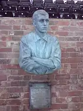  vue d'une sculpture de buste d'homme contre un mur de briques rouges
