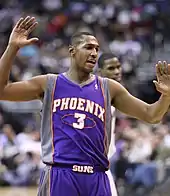 A basketball player, wearing a black jersey inscribed with the word "WOLVES" and the number 42 on the front.