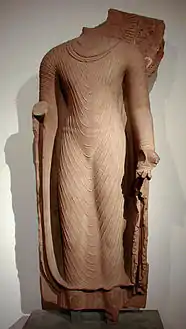 Bouddha acéphale en robe uttarâsangâ, daté du début du VIe siècle, école de Mathura, grès rose, Musée Guimet.