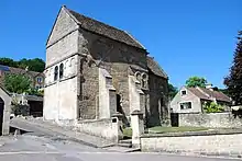 Photo d'un bâtiment de pierre grise de haute taille avec de rares fenêtres