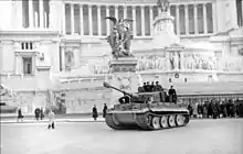 Image en noir et blanc avec un char armé au centre et un monument en arrière plan