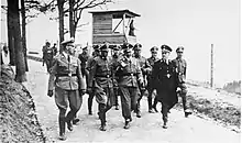 Photographie en noir et blanc d'Heinrich Himmler visitant le camp de concentration de Mauthausen en compagnie de son commandant, Franz Ziereis