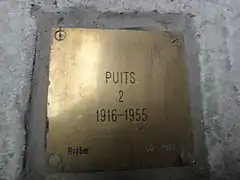 La plaque d'identification : « Puits 2, 1916-1955 ».
