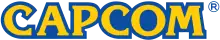 Logo de Capcom ; Capcom y est inscrit en lettres jaunes avec un fond bleu.