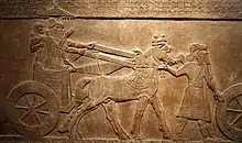 Bas-relief du Palais central représentant le roi Teglath-Phalasar III sur son char, au cours de la campagne contre la cité d'Astartu.