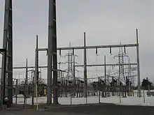Deux rangées parallèles de pylônes électriques.