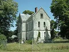 Photographie en couleurs du bâtiment construit sur un plan en croix.