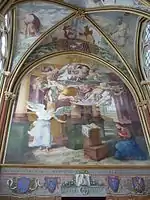 Scène sur un grand mur, avec l'ange à gauche et la Vierge agenouillée en bas à droite